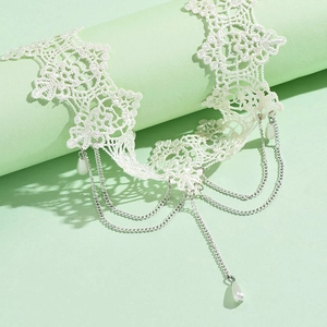 Multi-layer lace choker necklace with metallic chains and white pearl pendants on stand
