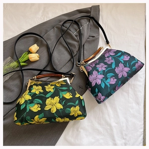 Detail of vintage embroidered floral handbags with wooden handles and delicate straps