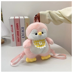 Pink plush penguin backpack with daisy bib detail and adjustable straps on white table