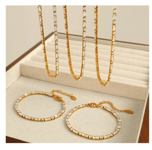 Detail of gold-plated stainless steel tennis bracelets with rectangle and round zircons