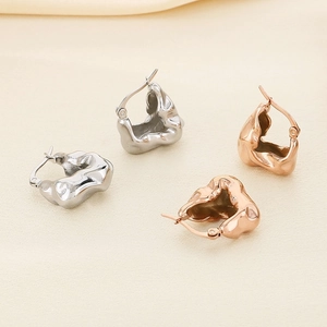 Irregular liquid metal style 18K gold earrings in silver and rose gold finishes