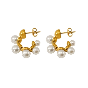Elegant gold C-shaped hoop earrings featuring five radiant white pearls on a white background