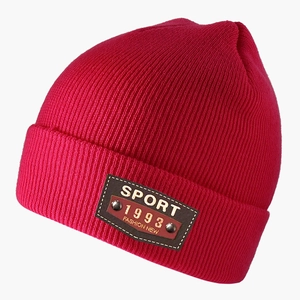 Detail view of pink knit beanie with leather patch featuring Sport and 1993 embroidery