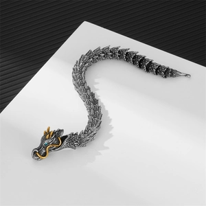 Retro dragon head bracelet in antique silver and gold with blue gemstone eyes