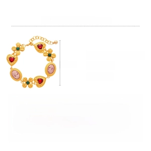 Detailed view of vintage gold bracelet with red heart rhinestones and cameo charm
