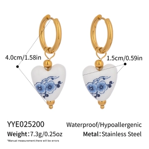 Detail view of heart-shaped ceramic drop earrings with dimensions and features