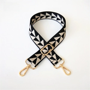 Adjustable shoulder strap with black and white geometric jacquard pattern and gold hardware