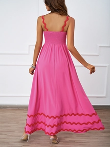 Detail view of pink maxi dress with scalloped edges and elastic smocked back design