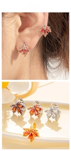 Macro detail of maple leaf earrings featuring colorful zircon inlay on copper metal