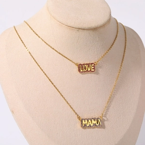 Double-layered gold necklace featuring LOVE and MAMA pendants with purple zircon stones