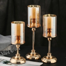 Three varying heights of vertical ribbed glass candle holders with gold metal bases