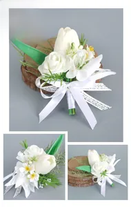 Detailed view of white rose and tulip wedding boutonniere with silk ribbon handle