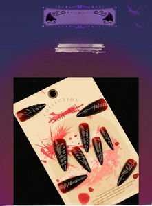 Detail of Halloween long stiletto press on nails with red black gradient and dark totems