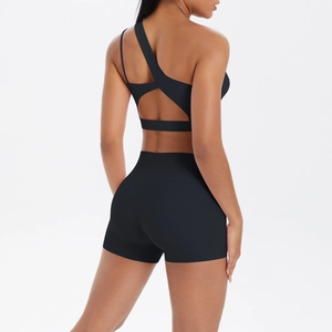 Detail of black one-shoulder yoga bra with triangle back cutout and high-waist shorts set