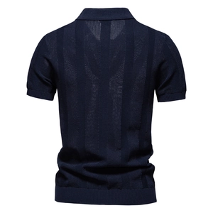 Macro shot of vertical stripe jacquard texture on men's navy blue knit polo shirt