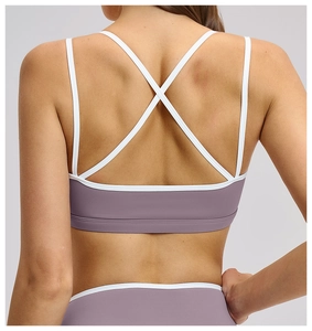 Close-up of the mauve sports bra featuring white contrast criss-cross back straps design