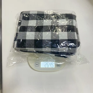 Weight measurement of six large black and white checkered Christmas stockings on a scale
