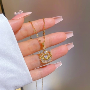Luxurious gold-plated titanium steel necklace featuring a zircon encrusted crown pendant