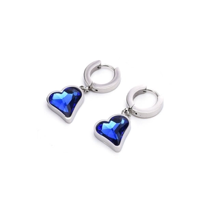 Detailed view of silver hoop earrings featuring sparkling heart-shaped blue crystals