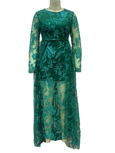 Close-up of deep green lace dress featuring sparkling gold embroidery and shimmering sequins