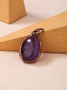 Macro shot of vintage oval amethyst pendant with antique bronze metal base detail