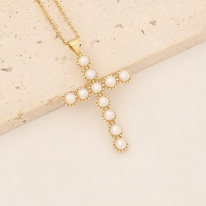 Macro detail of 18K gold plated cross pendant with micro-inlaid white pearls and fine chain