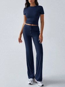 Detail of navy blue crop top and high-waisted flared trousers with drawstring waist
