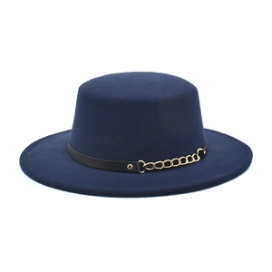 Detail of navy wool felt flat top hat with black leather band and gold metal chain