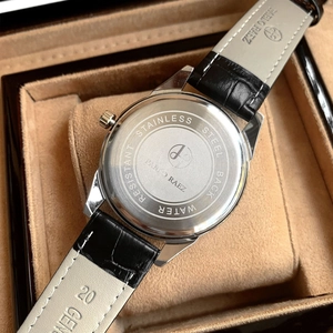 Detail of stainless steel case back and 20mm genuine leather strap on quartz watch