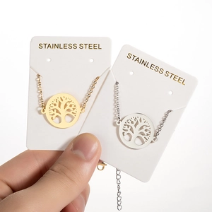 Minimalist Tree of Life cutout pendant necklace in gold and silver stainless steel