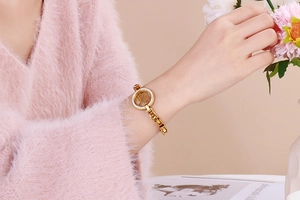 Close-up of gold Tree of Life bracelet with pavé zirconia on a female model