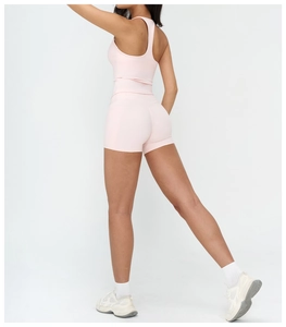 Rear view of peach pink yoga set showing racerback top and high waist shorts