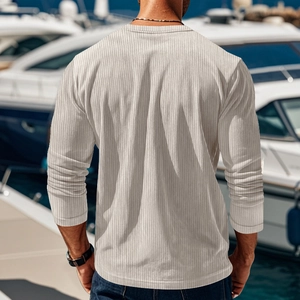 Back view of men's beige ribbed knit long sleeve shirt in a nautical outdoor setting
