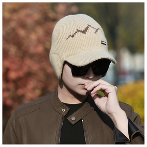 Winter beige knit hat with ear flaps and brown wave pattern on an outdoor male model