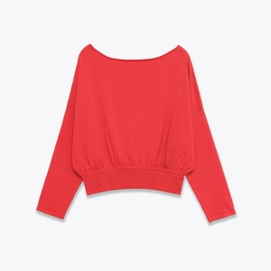 Detail view of red boat neck cropped knit top with ribbed cuffs and hem texture