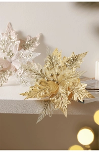 Close-up of sparkling gold and pink glitter poinsettia flowers for Christmas decoration