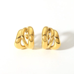Macro detail of triple layered spiral twist earrings with polished 18K gold plating