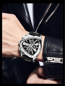 Close-up of triangle sport watch on wrist showing luminous dial and tachymeter details