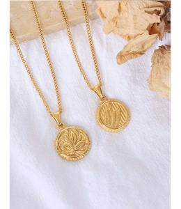 Detail of 18K gold plated wing pendant necklace with vintage embossed round coin texture