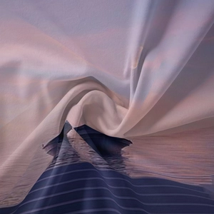 Detailed view of lightweight fabric showing draped texture and sunset mountain print