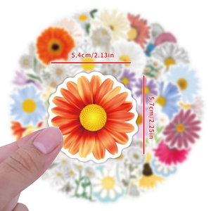 Sunflower vinyl sticker shown in hand measuring 5.7cm by 5.4cm for skateboards