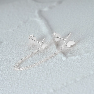Macro shot of S925 sterling silver butterfly studs with delicate fringe chains