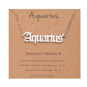 Silver Aquarius zodiac necklace on white card with descriptive text detail