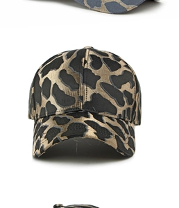 Close-up of black and gold jacquard leopard pattern fabric on a baseball cap