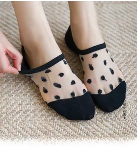 Detail view of women's black polka dot sheer mesh low-cut invisible liner socks
