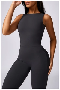 Detail of grey athletic bodysuit featuring seamless waist cut and premium matte fabric texture