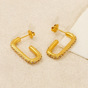 Detailed macro view of gold-plated rectangular earrings featuring pavé cubic zirconia
