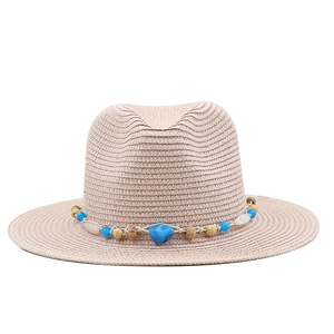 Detailed close-up of straw fedora with bohemian bead chain and natural shell accents
