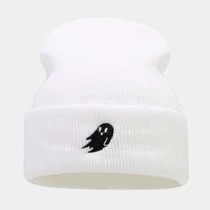 Close-up of white ribbed knit beanie with black ghost embroidery on the folded cuff