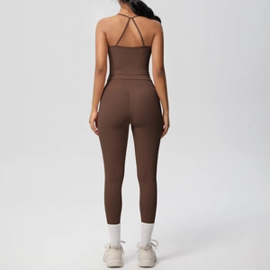 Women's dark brown yoga set featuring cross-back sports bra and high-waisted leggings